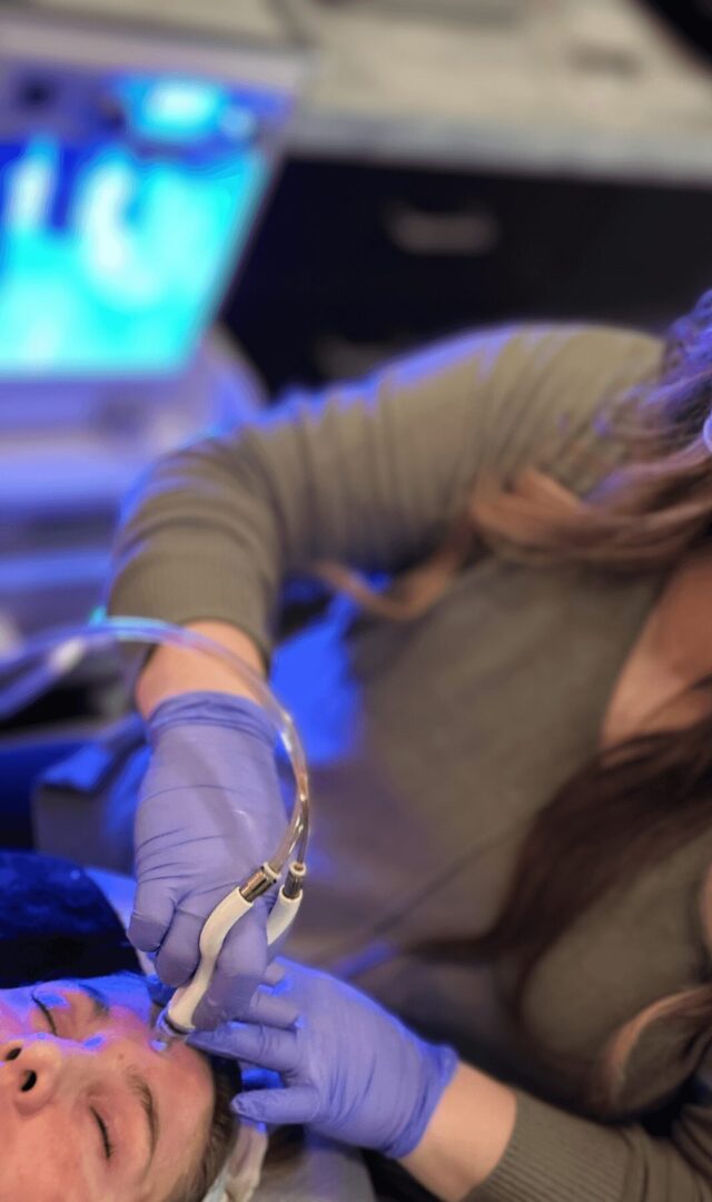 a person wearing gloves and holding a tube.